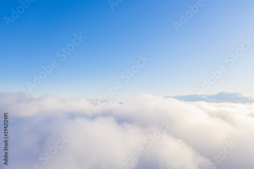 Aerial view white clouds in blue sky. Aerial top view cloudscape. Texture of clouds. View from above. Clouds texture background. Panorama clouds texture © Aleksei