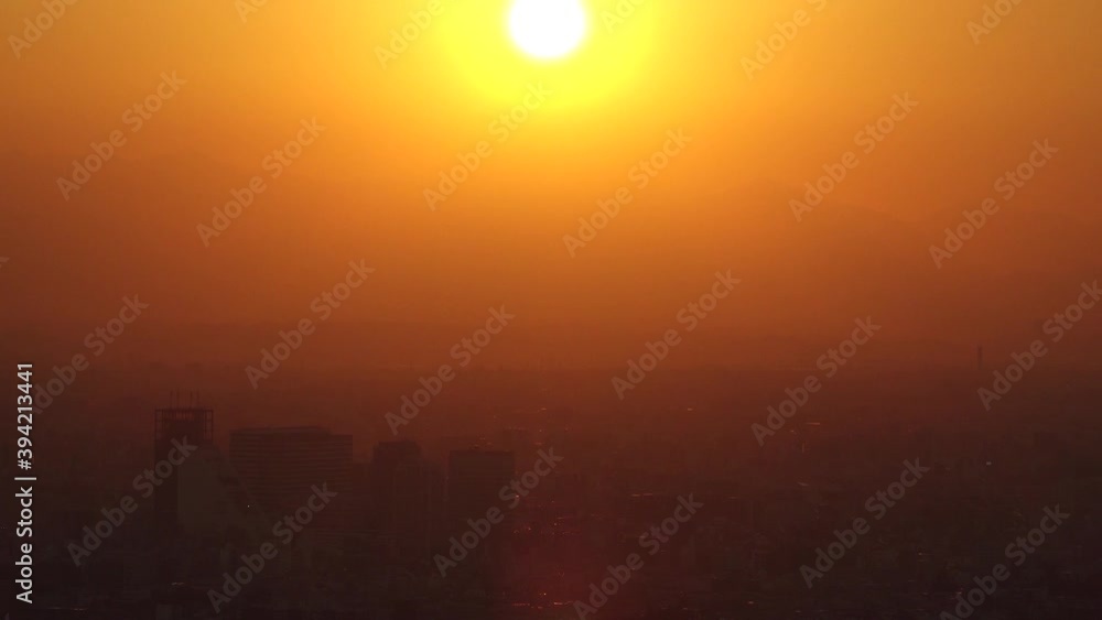 TOKYO, JAPAN : Aerial high angle sunset CITYSCAPE of TOKYO and MOUNT FUJI. Huge sun sinking behind mountains. Japanese city life and nature concept. Long time lapse zoom in shot dusk to night. TOKYO, JAPAN : Aerial high angle sunset CITYSCAPE of TOKYO and MOUNT FUJI. Huge sun sinking behind mountains. Japanese city life and nature concept. Long time lapse zoom in shot dusk to night.