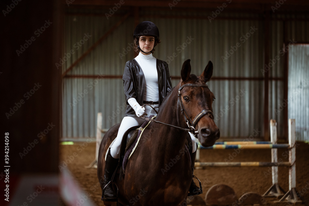Young woman is engaged in equestrian sports Young woman is engaged in equestrian sports
