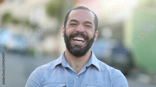 Happy man smiling and laughing portrait, person in 40s outside photo