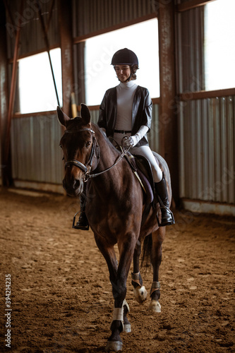 Young woman is engaged in equestrian sports © Екатерина Переславце