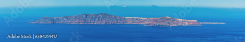 A panorama view of the island of Thirasia from the village of Imerovigli, Santorini in summertime