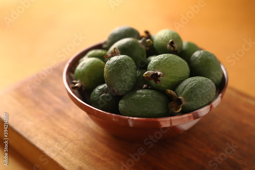 feijoa in a bowl on a wooden background