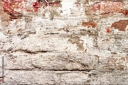 Texture of a brick wall with cracks and scratches which can be used as a background