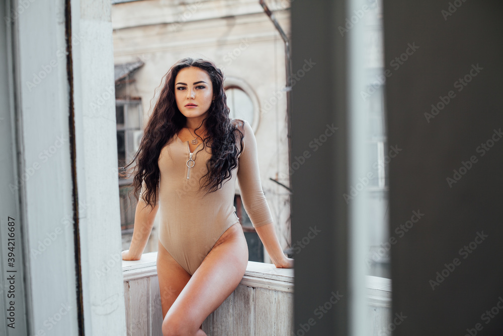 Portrait of a beautiful fashionable brunette woman in stylish clothes