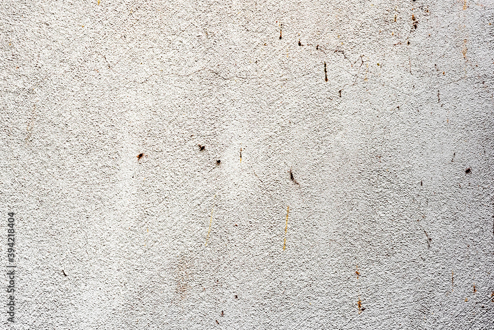 Texture of a concrete wall with cracks and scratches which can be used as a background Texture of a concrete wall with cracks and scratches which can be used as a background