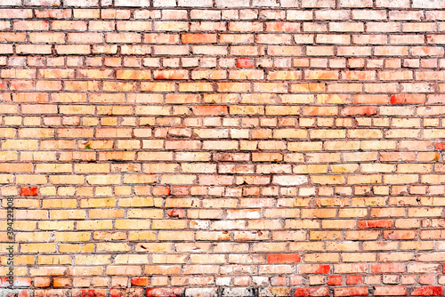 Texture of a brick wall with cracks and scratches which can be used as a background