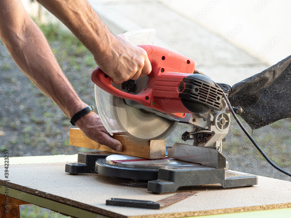 Circular Saw. Carpenter Using Circular Saw for wood beam