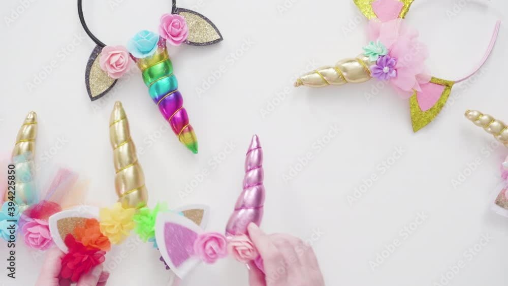 Flat lay. variety of unicorn headbands with pink feathers on a white background. Flat lay. variety of unicorn headbands with pink feathers on a white background.