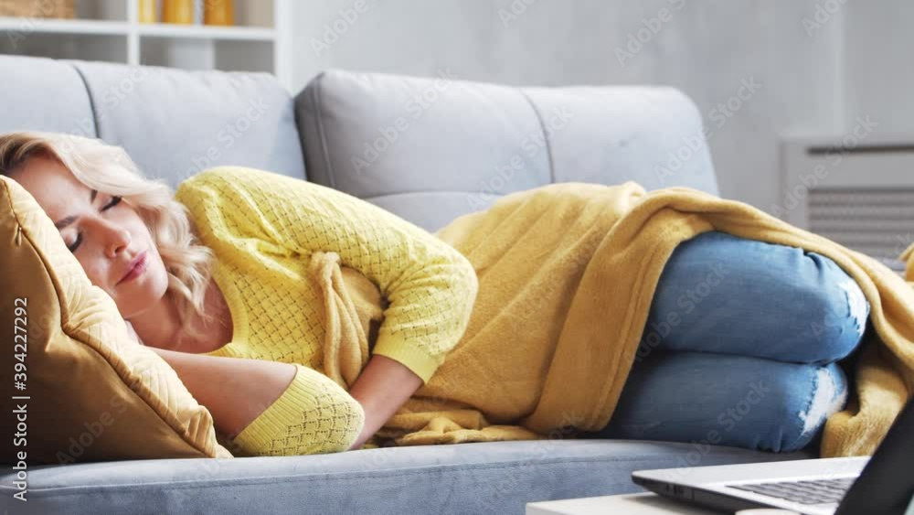 Freelancer girl tired of work sleeps on the couch in the morning. Woman fell asleep while working at home. Lockdown and remote job concepts. Freelancer girl tired of work sleeps on the couch in the morning. Woman fell asleep while working at home. Lockdown and remote job concepts.
