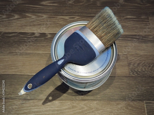 Paint brush on top of tin of paint