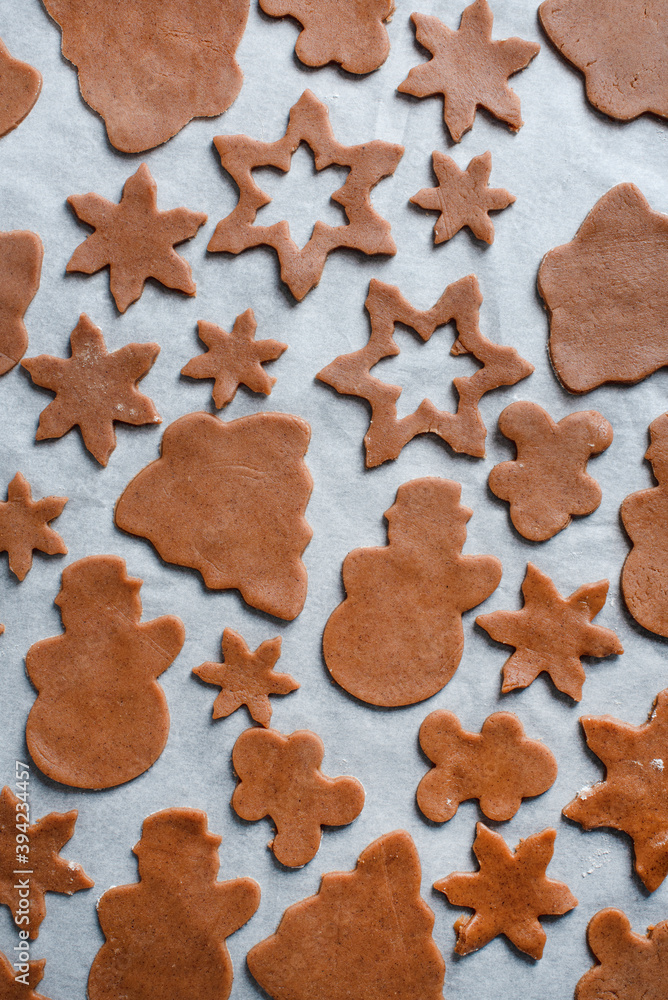 Cutting gingerbread dough with festive metal cutters. Flat lay. Making Christmas gingerbread cookies, holiday advent