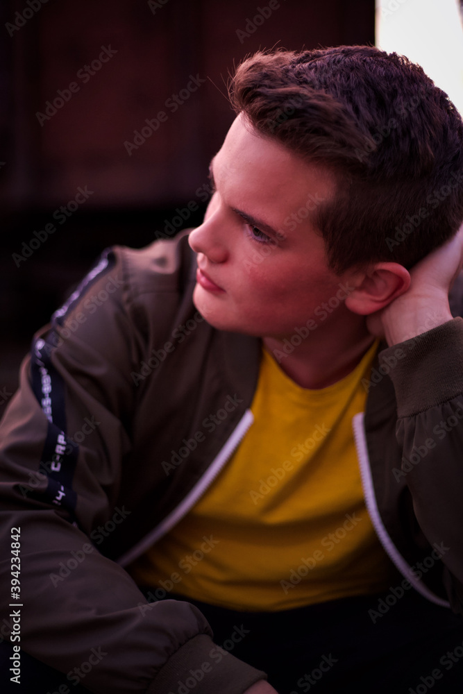A young man sitting on the railways and looking forward. A young man sitting on the railways and looking forward.