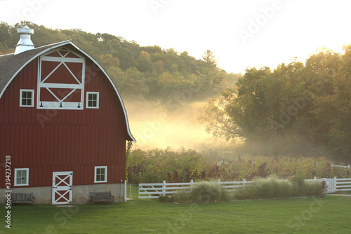 Red barn on a foggy autumn morning