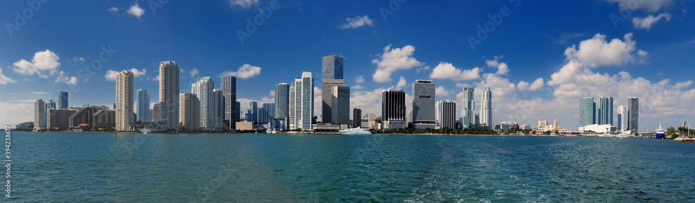 Panoramic View To The Skyline Of Miami From A Vessel On A Sunny Autumn Day With A Clear Blue Sky And A Few Clouds