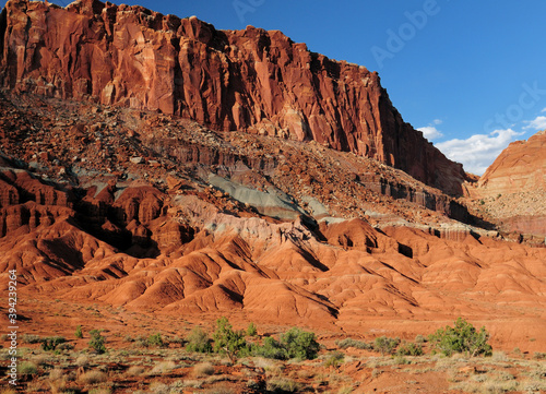 View To A Colorful Butte From Scenic Drive Road Capitol Reef National Park In The Late Afternoon Sun On A Sunny Summer Day With A Clear Blue Sky And A Few Clouds