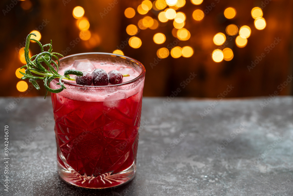 Christmas cranberry cocktail with lights in the background Christmas cranberry cocktail with lights in the background