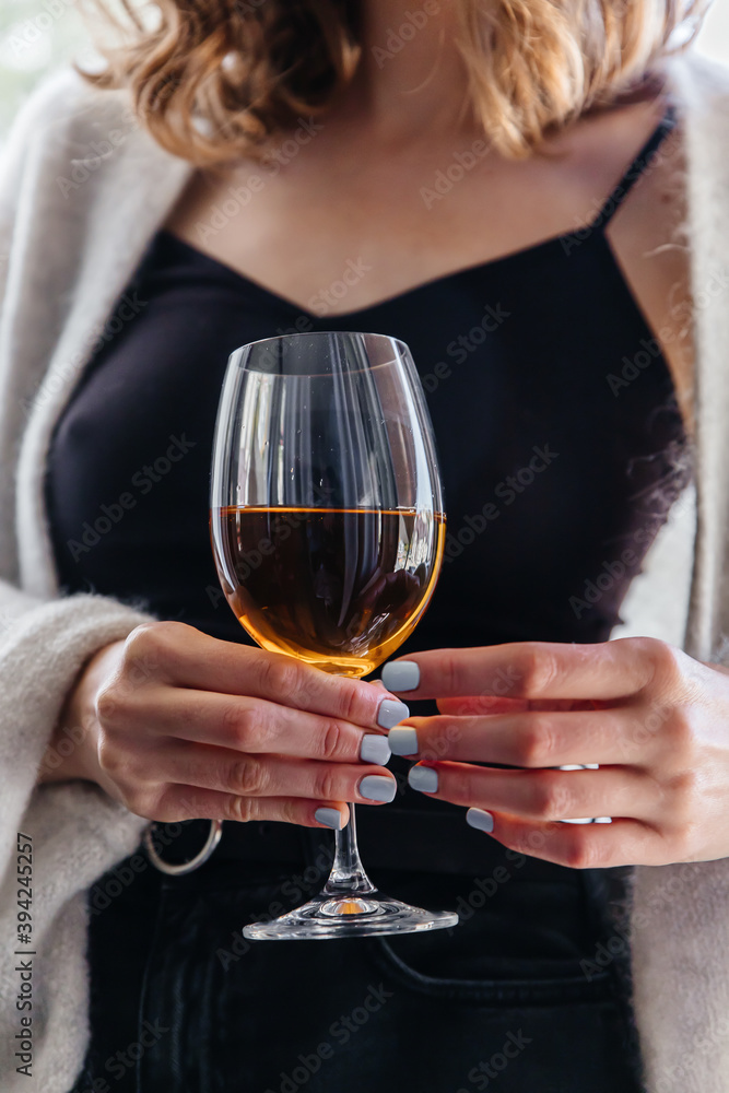 wine in a glass in the hands of a young girl wine in a glass in the hands of a young girl
