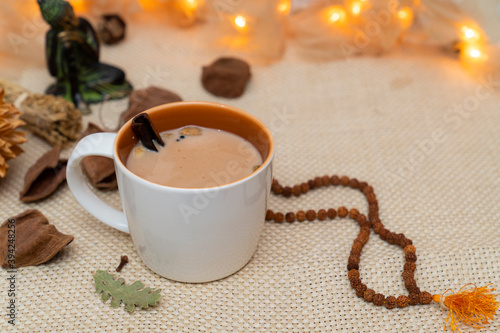 Yogi cinnamon tea on meditation decoration background. Alternative medicine with herbal tea. Healthy and relaxing life concept. Winter tea.