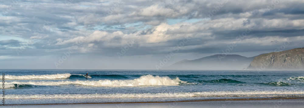 Obraz premium surfing at A Frouxeira beach in Galicia in northern Spain
