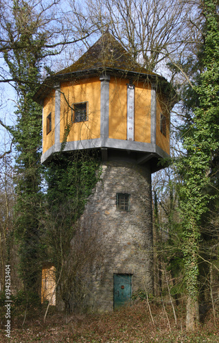 Lost place in a forest with a historical water tower and bare trees in the city of Diez in Germany © float