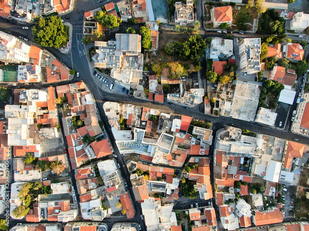 View of the city of Larnaca from above, shooting from a quadrocopter. Flat frame on the city streets. Horizontal panorama of southern Cyprus with the horizon line. The coastline and the sea.