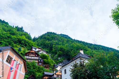 Colorful houses at picture-postcard view of famous Hallstatt mountain village in the Austrian Alps at beautiful light in autumn at Hallstatt, Austria. © Martin