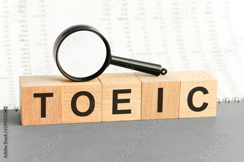Wooden Blocks with the text: TOEIC with magnifying glass.