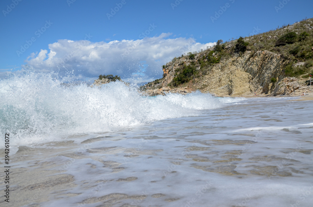 Waves crushing on tropical beach with yellow sand.  Huge waves on the sea.