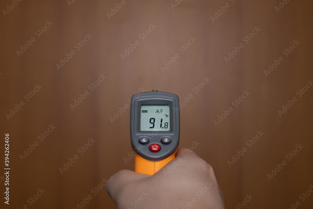 Holding a temperature meter Holding a temperature meter