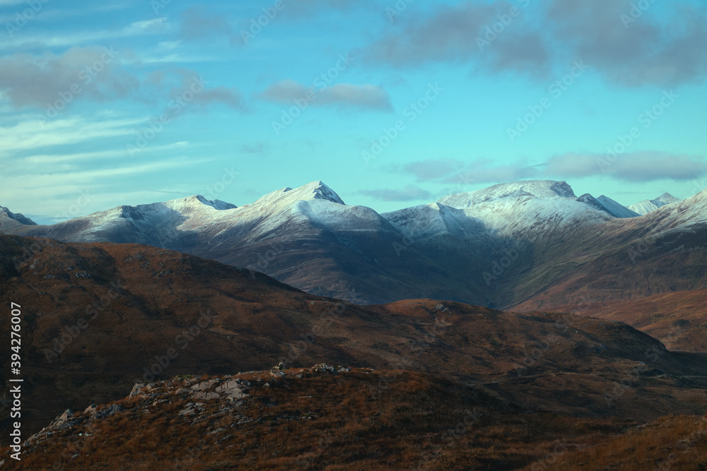Magnificent landscape of mountain peaks covered snow at sunset. View from The Devils Staircase to Binnein Mor that is the highest summit of the Mamores range. Highlands, Scotland