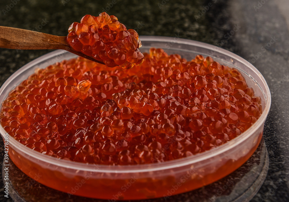 texture of red caviar, wooden spoon in red caviar texture of red caviar, wooden spoon in red caviar