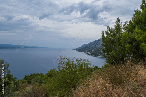 Looking down to the coastline in town of Brela on the Adriatic coastline of Croatia. Cloudy august day, 2020