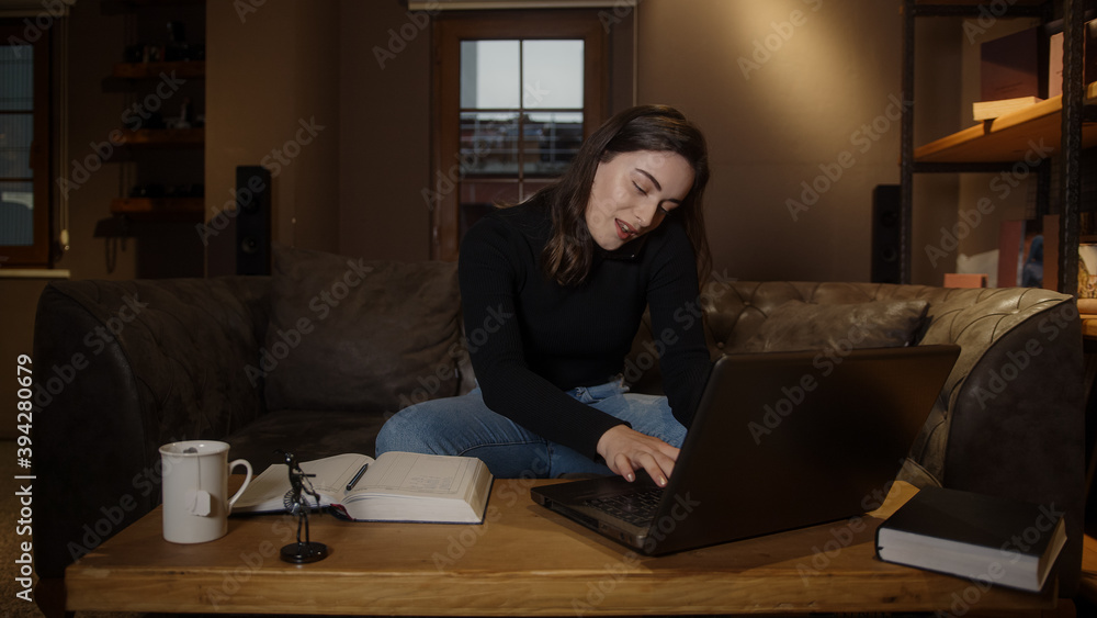 Young college or high school student pretty girl studying at table with laptop pen paper and talking by phone, pandemic distance education concept Young college or high school student pretty girl studying at table with laptop pen paper and talking by phone, pandemic distance education concept