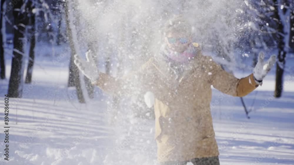 Happy young man throwing snow up in front of camera. Winter mood. Winter, sport, holidays, xmas, lifestyle concept. Filmed on cinema camera, 10 bit color space. Happy young man throwing snow up in front of camera. Winter mood. Winter, sport, holidays, xmas, lifestyle concept. Filmed on cinema camera, 10 bit color space.
