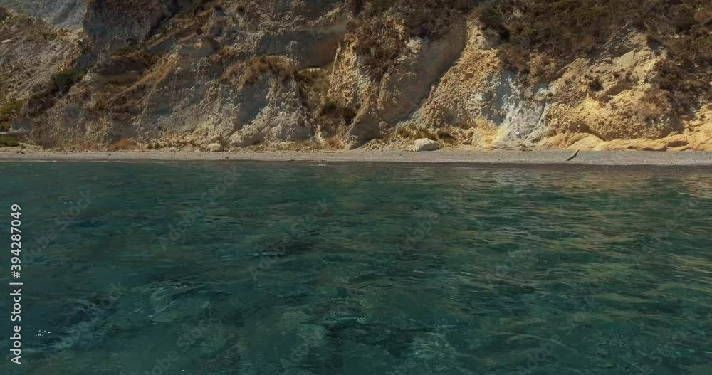 Aerial view low over turquoise sea, towards cliffs on the coast of the Ponza Island, in Italy - dolly, drone shot Aerial view low over turquoise sea, towards cliffs on the coast of the Ponza Island, in Italy - dolly, drone shot