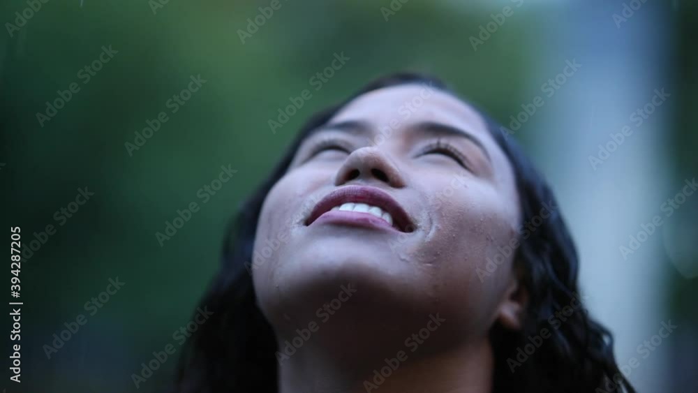 Happy woman looking up to sky while raining day Happy woman looking up to sky while raining day