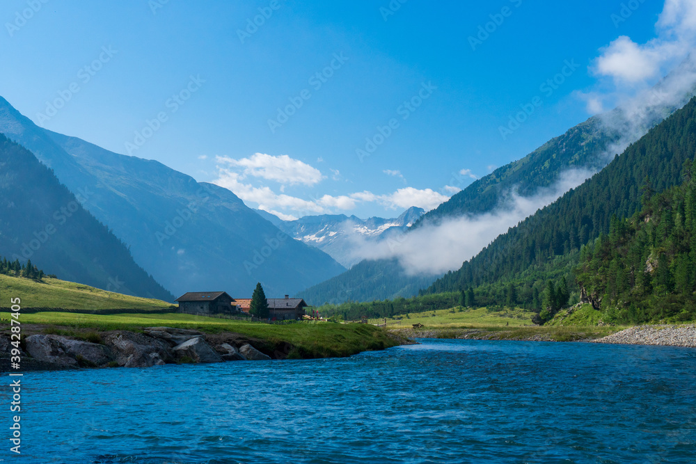Alpine landscape. High mountain alpine valley at summer. Tourist route Krimml Waterfalls - Hohe Tauern National Park. Austria. Famous tourism destination, tourist attraction Alpine landscape. High mountain alpine valley at summer. Tourist route Krimml Waterfalls - Hohe Tauern National Park. Austria. Famous tourism destination, tourist attraction