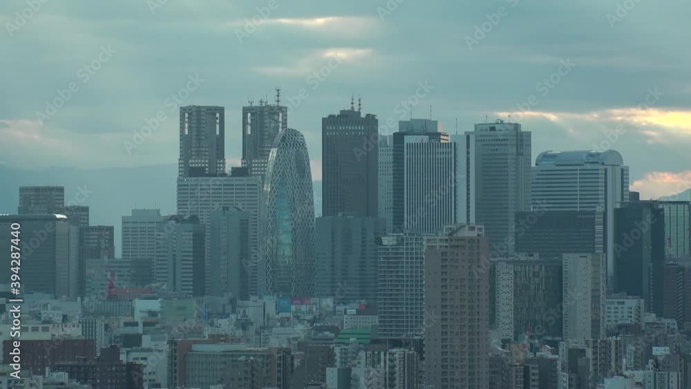 TOKYO, JAPAN : Aerial high angle sunset CITYSCAPE of TOKYO. View of buildings around Shinjuku. Japanese urban metropolis concept shot. Long time lapse shot dusk to night. Wide tracking shot. TOKYO, JAPAN : Aerial high angle sunset CITYSCAPE of TOKYO. View of buildings around Shinjuku. Japanese urban metropolis concept shot. Long time lapse shot dusk to night. Wide tracking shot.