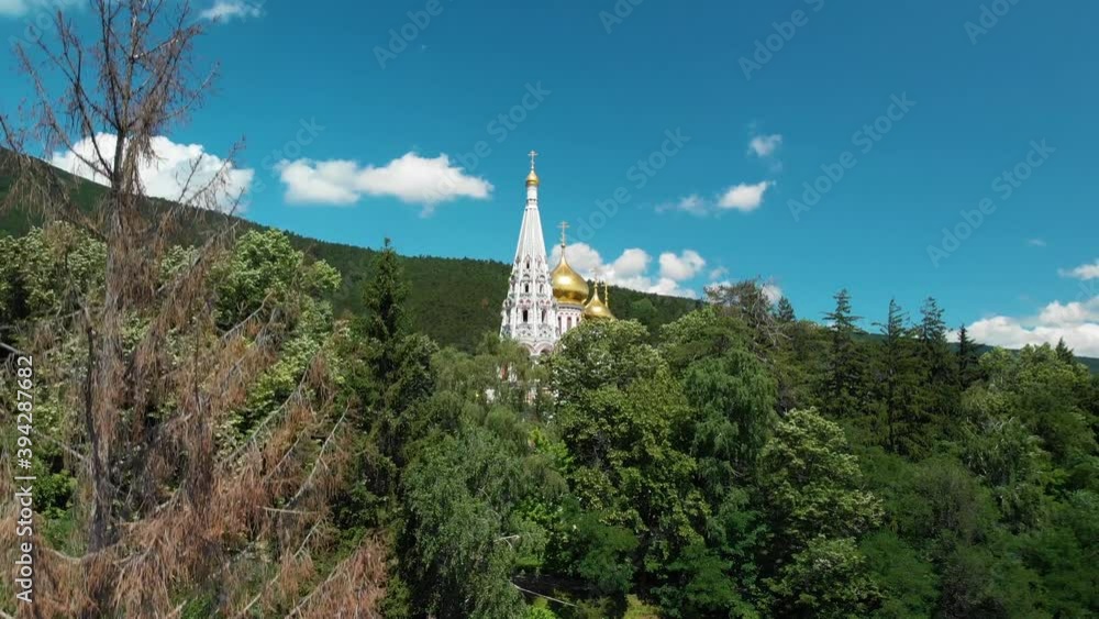 Church Of The Nativity With Golden Domes In Shipka, Bulgaria Surrounded By Dense Green Lush Foliage, Aerial Tilt-Down Shot Church Of The Nativity With Golden Domes In Shipka, Bulgaria Surrounded By Dense Green Lush Foliage, Aerial Tilt-Down Shot