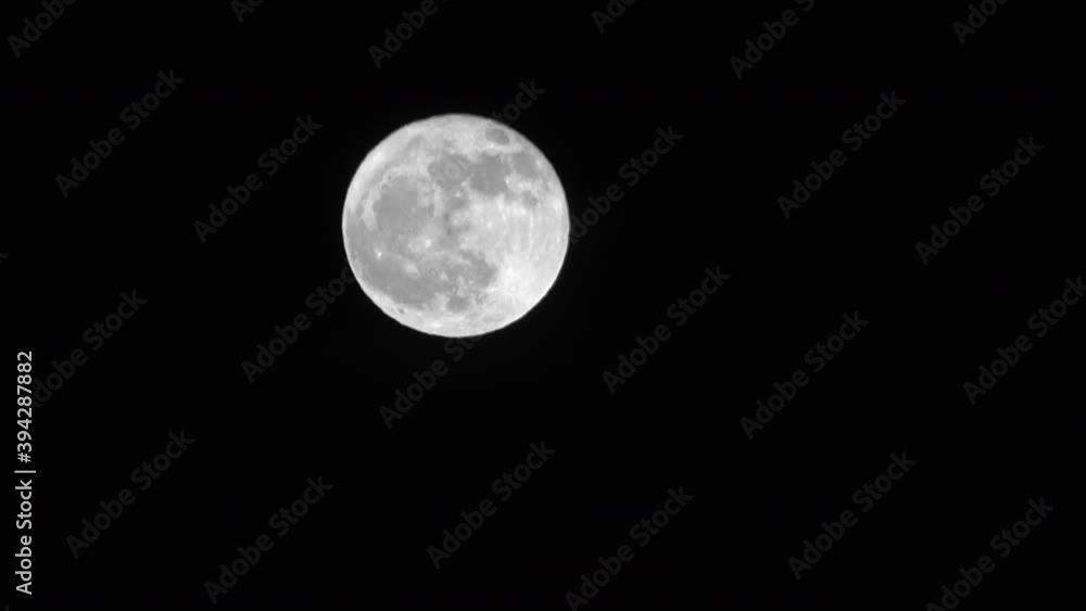 Bright full moon crosses night sky time lapse // 4K Bright full moon crosses night sky time lapse // 4K