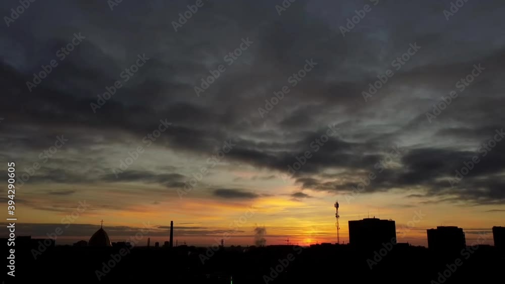 Aerial view of a drone flying over the city. Sunset in the sky. Aerial view of a drone flying over the city. Sunset in the sky.