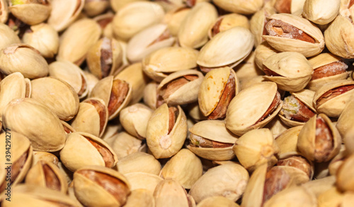 Roasted salty pistachio nuts in a shell background