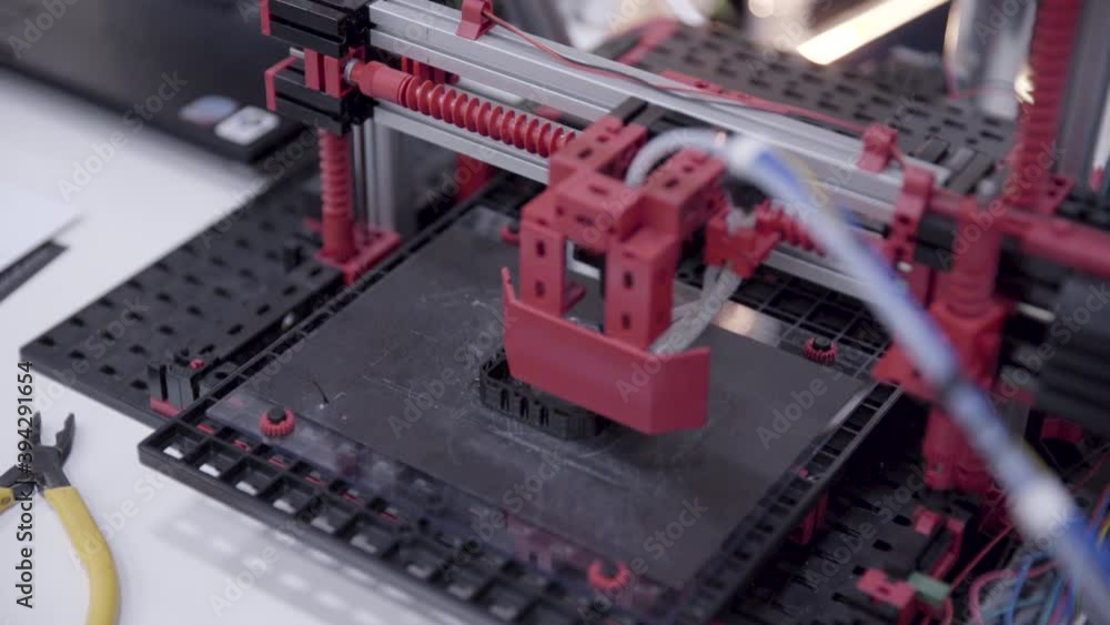 Close up of 3d printer printing black plastic part Close up of 3d printer printing black plastic part