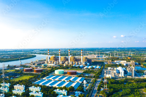 Electricity Authority Station, thermal power plant by the river, machine working to generate electricity, power station, electrical power plant. energy concept, evening sky. photo