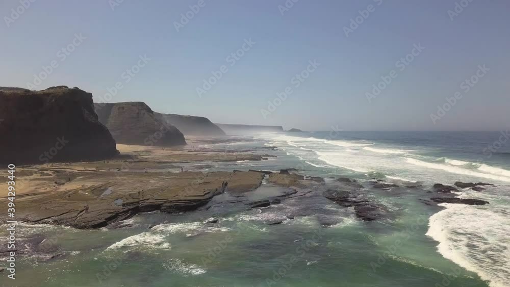 Drone flyover of the coastline during a swell in Portugal. Video shot in 4K UHD quality Drone flyover of the coastline during a swell in Portugal. Video shot in 4K UHD quality
