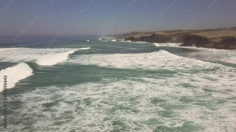 Forward aerial shot of the wavy coastline in Portugal. Video shot in 4K UHD quality Forward aerial shot of the wavy coastline in Portugal. Video shot in 4K UHD quality