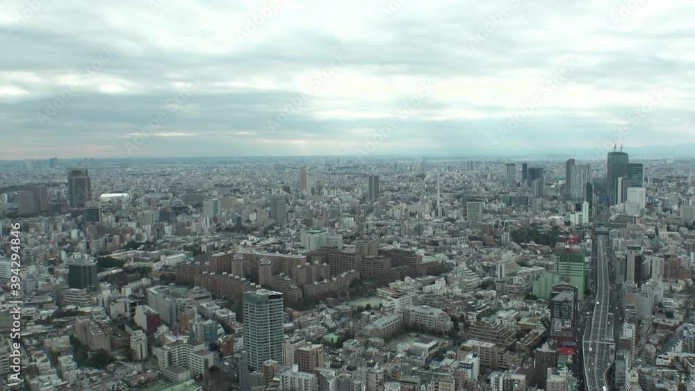 TOKYO, JAPAN : Aerial high angle view of CITYSCAPE of TOKYO in day time. View from Roppongi area. Dramatic sky and cityscape of Shibuya city on the right. Wide view time lapse tracking shot. TOKYO, JAPAN : Aerial high angle view of CITYSCAPE of TOKYO in day time. View from Roppongi area. Dramatic sky and cityscape of Shibuya city on the right. Wide view time lapse tracking shot.