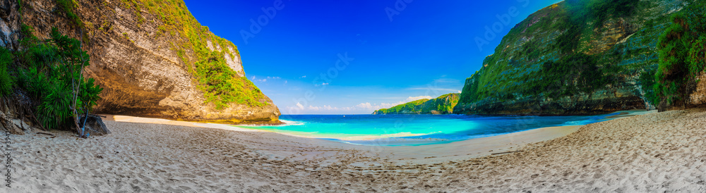 Atuh Beach with crystal clear azure water on background mountain landscape and blue summer sky. Bali, Indonesia Atuh Beach with crystal clear azure water on background mountain landscape and blue summer sky. Bali, Indonesia