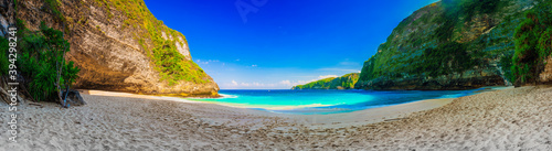 Fototapeta Naklejka Na Ścianę i Meble -  Atuh Beach with crystal clear azure water on background mountain landscape and blue summer sky. Bali, Indonesia